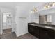 Bathroom featuring double vanity, granite counters, and large mirrors at 14193 Gold Bridge Dr, Orlando, FL 32824