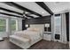 Stylish bedroom features wood beams, ample natural light, and neutral tones at 14193 Gold Bridge Dr, Orlando, FL 32824