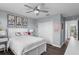 Bedroom with wood-look flooring, closet with doors, and bed with decorative pillows, illuminated by ceiling fan at 14193 Gold Bridge Dr, Orlando, FL 32824
