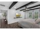 Inviting bedroom showcasing decorative wood beams, a large bed, and a view of the outdoors at 14193 Gold Bridge Dr, Orlando, FL 32824
