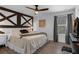 Bedroom with wood-look flooring, decorated accent wall, and a plush bed, illuminated by modern lighting at 14193 Gold Bridge Dr, Orlando, FL 32824