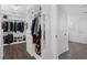 This walk-in closet has custom organizers with shelves, drawers, and a mirror accent wall, with wood-look flooring at 14193 Gold Bridge Dr, Orlando, FL 32824