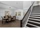 Elegant dining room with dark wood table, staircase, and stylish light fixture at 14193 Gold Bridge Dr, Orlando, FL 32824