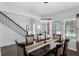 Bright dining space showcases dining table, chairs, and a staircase near the front door at 14193 Gold Bridge Dr, Orlando, FL 32824