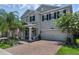 Stylish two-story house showcases a brick driveway and lush landscaping at 14193 Gold Bridge Dr, Orlando, FL 32824