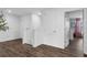 Upstairs hallway with wood look flooring, closet door, and doorway with visible bedroom accents at 14193 Gold Bridge Dr, Orlando, FL 32824
