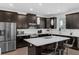 Modern kitchen equipped with stainless steel appliances, island, and ample cabinet space at 14193 Gold Bridge Dr, Orlando, FL 32824