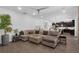 Spacious living room with a large sectional sofa, modern ceiling fan, and stylish decor at 14193 Gold Bridge Dr, Orlando, FL 32824