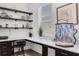 Bright home office featuring built-in desk, floating shelves, and natural light at 14193 Gold Bridge Dr, Orlando, FL 32824