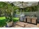Outdoor kitchen with stainless steel grill and counter space at 14193 Gold Bridge Dr, Orlando, FL 32824