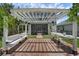 Outdoor pergola with seating, brick patio, and view of screened patio at 14193 Gold Bridge Dr, Orlando, FL 32824