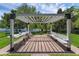 Backyard pergola with a seating area, overlooking a water view at 14193 Gold Bridge Dr, Orlando, FL 32824