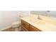 Bathroom with beige toilet and sink featuring a wood cabinet with updated flooring at 1424 Mt Laurel Dr, Winter Springs, FL 32708