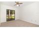 Bedroom featuring neutral carpet, a ceiling fan and a sliding glass door to the private outdoor space at 1424 Mt Laurel Dr, Winter Springs, FL 32708