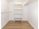 Walk-in closet with white shelving and light wood floors at 1424 Mt Laurel Dr, Winter Springs, FL 32708