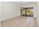 Bright dining room featuring new flooring, a modern light fixture and sliding glass doors to the screened porch at 1424 Mt Laurel Dr, Winter Springs, FL 32708