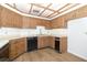 Kitchen featuring white countertops, wood cabinets and black appliances with updated flooring at 1424 Mt Laurel Dr, Winter Springs, FL 32708