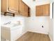 Utility room featuring a utility sink, oak cabinets, and vinyl flooring at 1424 Mt Laurel Dr, Winter Springs, FL 32708