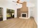Bright living room featuring wood-look floors, a fireplace, and access to the outdoors, combining comfort and convenience at 1424 Mt Laurel Dr, Winter Springs, FL 32708
