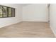Bright living room featuring wood-look floors, a large window, and neutral walls, creating a versatile living space at 1424 Mt Laurel Dr, Winter Springs, FL 32708