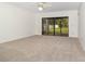Spacious living room featuring neutral carpet, ceiling fan and a sliding door to the backyard at 1424 Mt Laurel Dr, Winter Springs, FL 32708