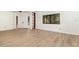 Bright living room with wood-look floors, built-in shelving, and large windows offering natural light and a welcoming ambiance at 1424 Mt Laurel Dr, Winter Springs, FL 32708