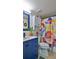A bathroom with a trendy blue vanity, stylish mirror, colorful shower curtain, and updated fixtures to create a relaxing haven at 145 N Halifax Ave # 705, Daytona Beach, FL 32118