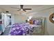 Relaxing bedroom with ample closet space, ceiling fan, and plush bedding for a restful sleep at 145 N Halifax Ave # 705, Daytona Beach, FL 32118