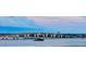Scenic water view of the bridge featuring modern street lamps and lush green trees on the horizon at 145 N Halifax Ave # 705, Daytona Beach, FL 32118