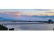 Wide water view of the bridge featuring a tranquil waterway and modern city buildings on the horizon at 145 N Halifax Ave # 705, Daytona Beach, FL 32118