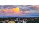 Scenic city skyline view at dusk, showcasing residential and business buildings beneath a fiery, colorful sky at 145 N Halifax Ave # 705, Daytona Beach, FL 32118