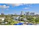 City view featuring modern buildings, verdant treetops, and visible parking, creating an inviting urban landscape at 145 N Halifax Ave # 705, Daytona Beach, FL 32118