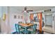 Inviting dining area with stylish table, seating and ceiling fan opens to a well-equipped kitchen at 145 N Halifax Ave # 705, Daytona Beach, FL 32118