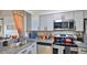 Stylish kitchen with gray cabinets, granite countertops, and stainless steel appliances, ideal for modern cooking at 145 N Halifax Ave # 705, Daytona Beach, FL 32118