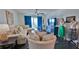 Bright living room with comfortable seating, stylish decor and balcony access offers a relaxing retreat at 145 N Halifax Ave # 705, Daytona Beach, FL 32118