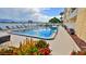 Community pool with clear blue water, surrounded by palm trees and lush greenery offering a tropical and refreshing oasis at 145 N Halifax Ave # 705, Daytona Beach, FL 32118