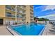 Inviting community pool with lounge chairs and building backdrop in this condo neighborhood at 145 N Halifax Ave # 705, Daytona Beach, FL 32118