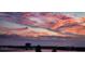 Picturesque sunset view featuring cloud filled pink skies over a tranquil body of water at 145 N Halifax Ave # 705, Daytona Beach, FL 32118