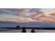 Scenic view of the river and city skyline under a vibrant sunset sky, showcasing a peaceful location at 145 N Halifax Ave # 705, Daytona Beach, FL 32118