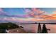Picturesque water view featuring tropical trees, building rooftops and tranquil blue skies at 145 N Halifax Ave # 705, Daytona Beach, FL 32118