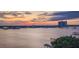 Picturesque waterfront view with a pier, boats, and a vibrant sunset, highlighting the community's coastal lifestyle at 145 N Halifax Ave # 705, Daytona Beach, FL 32118