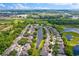 Stunning aerial view of homes surrounding a pond with beautiful landscaping and community greenery at 1461 Travertine Ter, Sanford, FL 32771