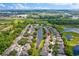 Stunning aerial view of homes surrounding a pond with beautiful landscaping and community greenery at 1461 Travertine Ter, Sanford, FL 32771