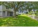 Serene backyard with lush green lawn, mature trees, and peaceful pond views, perfect for relaxing at 1461 Travertine Ter, Sanford, FL 32771