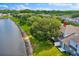 Backyard featuring a peaceful pond view, lush greenery, and a well-maintained lawn and fence at 1461 Travertine Ter, Sanford, FL 32771