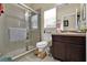 Bathroom features a stand up shower, a white toilet and a vanity with a dark wood cabinet and sink at 1461 Travertine Ter, Sanford, FL 32771