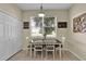 Bright dining room features a charming table set, a window and a neutral color palette at 1461 Travertine Ter, Sanford, FL 32771