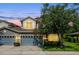 Charming two-story home featuring an attached two-car garage and a well-manicured front yard during twilight at 1461 Travertine Ter, Sanford, FL 32771