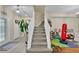 Welcoming two-story foyer features staircase and tile flooring at 1461 Travertine Ter, Sanford, FL 32771