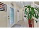 Bright entryway features a decorative door, a houseplant, and a tile floor at 1461 Travertine Ter, Sanford, FL 32771
